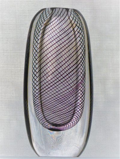 Vicke Lindstrand designed this vase, described in the catalogue as 'Black Threads,, in 1958 for Kosta. The internal spirals are actually dark amethyst rather than black.